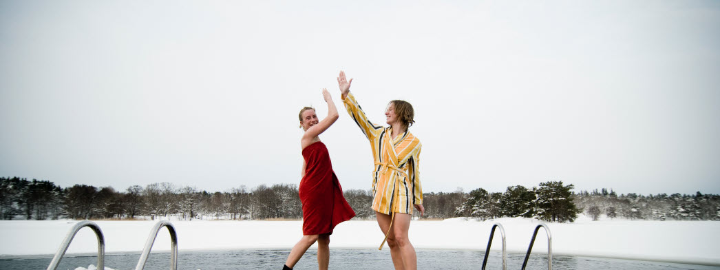 Två kvinnor ger varandra en high5 efter ett isbad